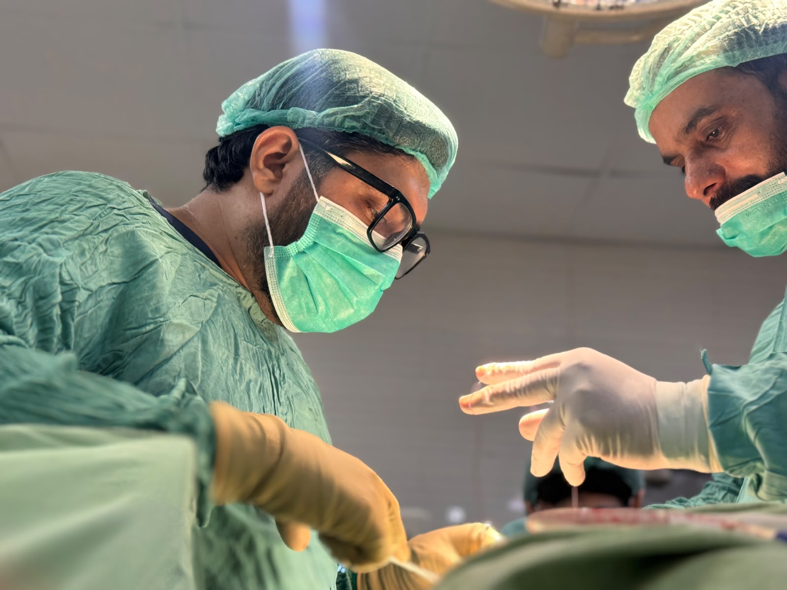 Dr. Arslan Ali performing orthopedic surgery with his surgical team